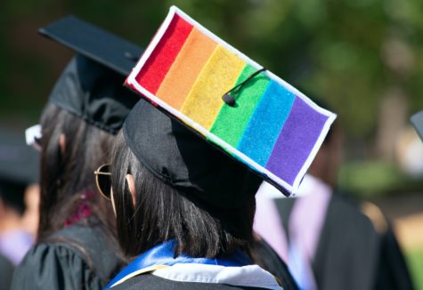 A graduating senior with the LGBTQ flag on her graduation cap.