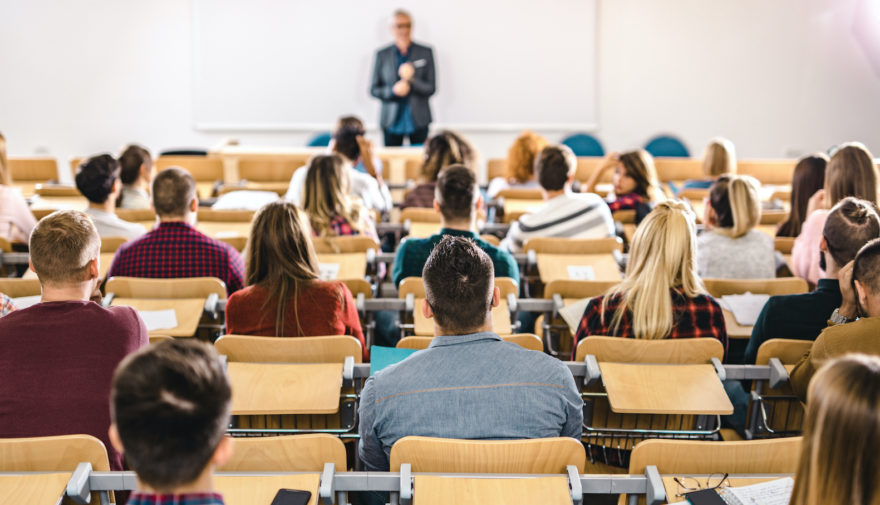 Students sitting in a lecture hall during a university class.